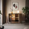 A modern living room with a cabinet, artwork, and a plant. Produktbild-Vorschau