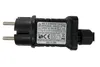 A close-up of a black power adapter with text and symbols on a white background. Produktbild-Vorschau