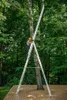 A person is using a ladder in a forest setting. Náhľad obrázku produktu