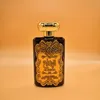 A perfume bottle with ornate gold detailing against an orange background. Produktbild-Vorschau