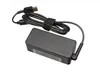 A black laptop charger with a coiled cable and a slim tip connector. Produktbild-Vorschau