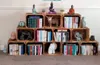 Wooden crates stacked and filled with books and decorative items, arranged as a bookshelf. Produktbild-Vorschau