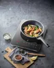 A frying pan with shrimp and vegetables is cooking on an induction hob. Podgląd zdjęcia produktu
