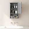 A gray bathroom cabinet with its door open, displaying various toiletries and decorative items. Podgląd zdjęcia produktu