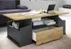 A modern coffee table with storage is placed in a living room setting. Voir les images du produit