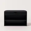 A black shoe cabinet with a padded seat on top, shown against a white background. Náhľad obrázku produktu