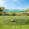 A tortoise is inside a hexagonal metal enclosure with a green mesh cover on a grassy lawn. Produktbild-Vorschau