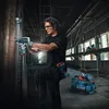 A construction worker is using a Bosch drill in a building under construction. Anteprima dell’immagine prodotto