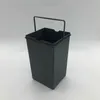A dark gray trash can with a wire handle on a white background. Produktbild-Vorschau