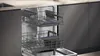 An open dishwasher with its racks pulled out, showing the interior. Produktbild-Vorschau