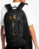 A person wearing a white t-shirt and black leggings, carrying a black camouflage backpack with gold Under Armour branding. Náhled obrázku produktu