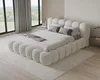 A bedroom with a large, plush bed and large windows overlooking a landscape. Voir les images du produit