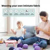 A mother and child are sitting on the floor with a knitting machine and yarn. Náhled obrázku produktu