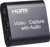 A black video capture device with HDMI input and audio ports. Produktbild-Vorschau