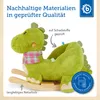 A green plush dinosaur rocking toy on a wooden base, with text overlays highlighting its features and certifications. Produktbild-Vorschau