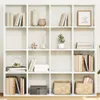A white modular bookshelf filled with various decorative items and books. Voir les images du produit