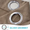 Close-up of two silver grommets on a textured brown fabric, with a measurement graphic at the bottom. Produktbild-Vorschau