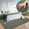 A bedroom scene with a bed, rug, and decor. Produktbild-Vorschau