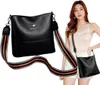 A woman is posing with a black handbag, which is also shown separately. Náhľad obrázku produktu