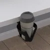 A coffee cup in a holder on the edge of a white surface. Anteprima dell’immagine prodotto