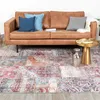 A living room scene with a brown leather sofa and a patchwork rug. Produktbild-Vorschau