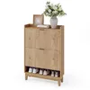 A shoe cabinet with two flip drawers and an open shelf at the bottom, displaying shoes. A vase of flowers and a picture frame are on top. Podgląd zdjęcia produktu