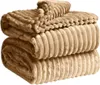 A stack of folded blankets with a ribbed texture. Produktbild-Vorschau