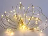 A close-up shot of a battery-operated string of 100 warm white LED lights on a thin silver wire, bunched together. Náhled obrázku produktu