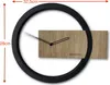 A modern wall clock with a wooden face and a black circular frame, with dimensions indicated. Anteprima dell’immagine prodotto