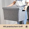 A person is holding a grey felt storage box with a lid and handles. Produktbild-Vorschau