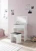 A white vanity table with a mirror and a black stool in a room with pink walls. Produktbild-Vorschau