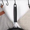 A frying pan handle is shown hanging from a hook, with two pot holders on either side. Náhled obrázku produktu