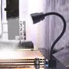 A close-up of a magnetic LED lamp attached to a machine, illuminating a component. Produktbild-Vorschau