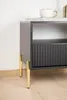 A close-up view of a modern furniture leg attached to a dark cabinet. Produktbild-Vorschau