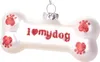 A white bone-shaped Christmas ornament with red paw prints and the text "I ❤️ my dog" written on it. Náhled obrázku produktu