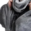 Hands holding and folding a soft, gray blanket. Produktbild-Vorschau