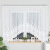 A white lace curtain with a decorative pattern is shown hanging in front of a window. Náhled obrázku produktu