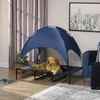 A golden retriever dog is resting on a raised pet bed with a blue canopy in a living room setting. Produktbild-Vorschau