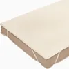 A close-up, angled view of a cream-colored mattress protector on a mattress. Náhled obrázku produktu