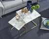 A living room setting with a sofa, nesting coffee tables, and decorative items. Produktbild-Vorschau