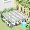 A clear plastic tarp greenhouse setup in a garden with potted plants. Produktbild-Vorschau