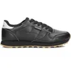 A black Skechers sports shoe with a tan sole is shown from the side against a white background. Produktbild-Vorschau