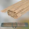 A rolled-up bamboo mat is shown, with a second image showing the mat packaged in a green carrying bag. Podgląd zdjęcia produktu
