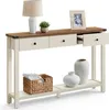 A console table with drawers and a shelf, decorated with a lamp, plant, picture frame, basket, and vases. Náhled obrázku produktu