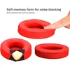 Three red ear pads for headphones are shown, with one being pressed by a finger to demonstrate its softness and elasticity. Another ear pad is shown with a cutaway revealing the yellow memory foam interior. Produktbild-Vorschau