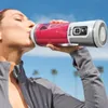 A woman drinks a smoothie from a portable blender outdoors. Podgląd zdjęcia produktu