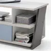 A close-up view of a TV lowboard with shelves containing DVDs and a decorative tin. Produktbild-Vorschau