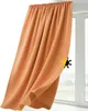 A close-up of an orange curtain hanging in front of a window. Produktbild-Vorschau