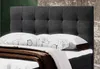 A close-up view of a bed with a tufted headboard, pillows, and a blanket. Náhľad obrázku produktu
