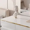 A close-up of a white desk with a decorative bust on it. Produktbild-Vorschau